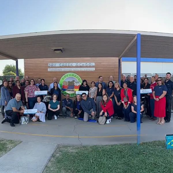Group of volunteers for standing together posing for a group photo for Junior Achievement of Sacramento's recent JA In-A-Day program at Dry Creek Elementary School